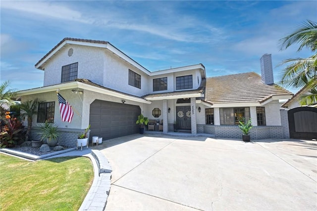 3380 E Date St, Brea, CA 92823 - view of front of home with brick siding, driveway, stucco siding, and an attached garage