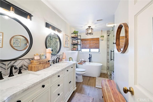 3380 E Date St, Brea, CA 92823 - full bathroom with wood finished floors, double vanity, a stall shower, and a soaking tub