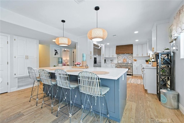 3380 E Date St, Brea, CA 92823 - kitchen with appliances with stainless steel finishes, light countertops, light wood-style floors, white cabinets, and recessed lighting