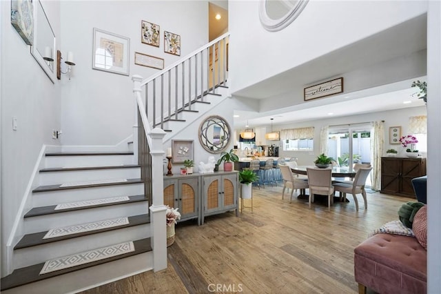3380 E Date St, Brea, CA 92823 - stairs featuring wood finished floors, a high ceiling, and recessed lighting