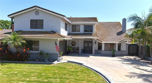 3380 E Date St, Brea, CA 92823 - view of front of property with concrete driveway, a garage, a chimney, stucco siding, and a front yard