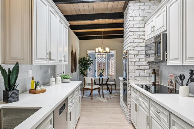 820 Robin Ln, Millbrae, CA 94030 - kitchen featuring appliances with stainless steel finishes, a chandelier, backsplash, light wood-type flooring, and white cabinets