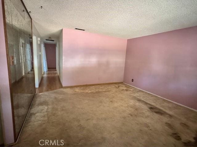3246 Shamrock Ave, Merced, CA 95340 - carpeted empty room with a textured ceiling