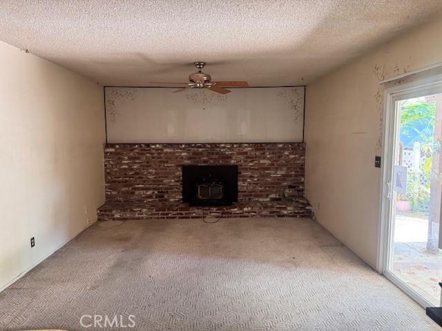 3246 Shamrock Ave, Merced, CA 95340 - unfurnished living room featuring carpet floors, a ceiling fan, and a textured ceiling