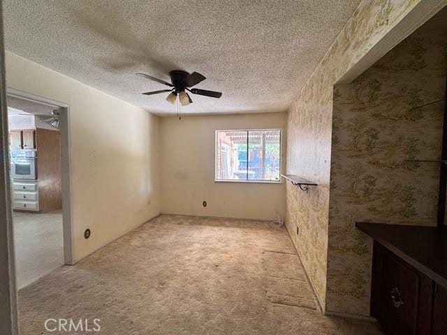 3246 Shamrock Ave, Merced, CA 95340 - unfurnished room featuring carpet floors, ceiling fan, and a textured ceiling