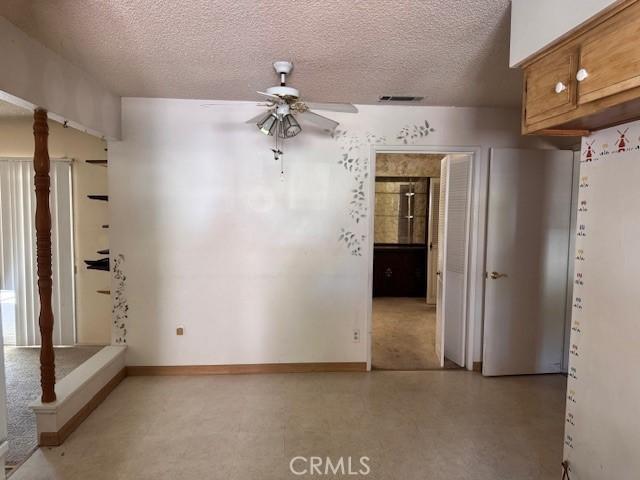 3246 Shamrock Ave, Merced, CA 95340 - empty room with ceiling fan and a textured ceiling
