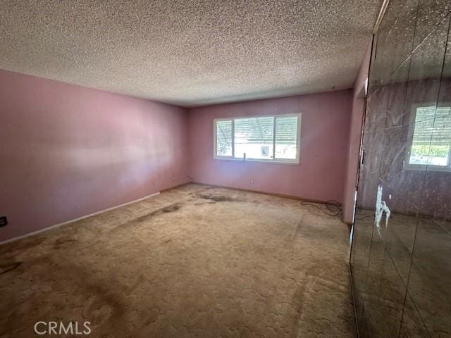 3246 Shamrock Ave, Merced, CA 95340 - carpeted spare room with plenty of natural light and a textured ceiling