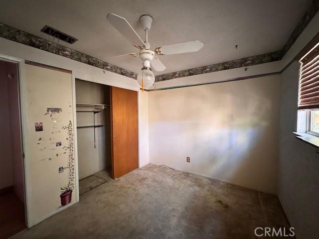 3246 Shamrock Ave, Merced, CA 95340 - unfurnished bedroom featuring a closet, carpet, and a ceiling fan
