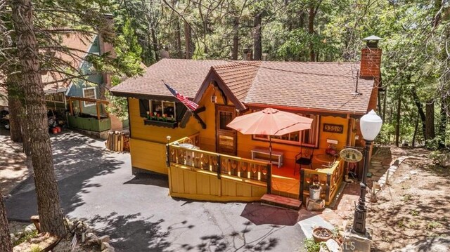 33019 Juniper Ln, Green Valley Lake, CA 92341 - rear view of property with a chimney, a wooden deck, and a shingled roof