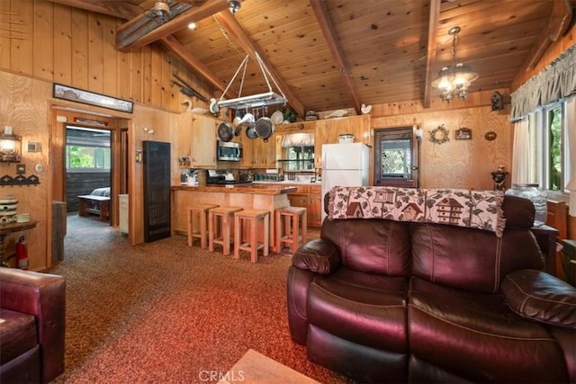 33019 Juniper Ln, Green Valley Lake, CA 92341 - carpeted living room featuring a wood ceiling with exposed beams, wooden walls, and high vaulted ceiling