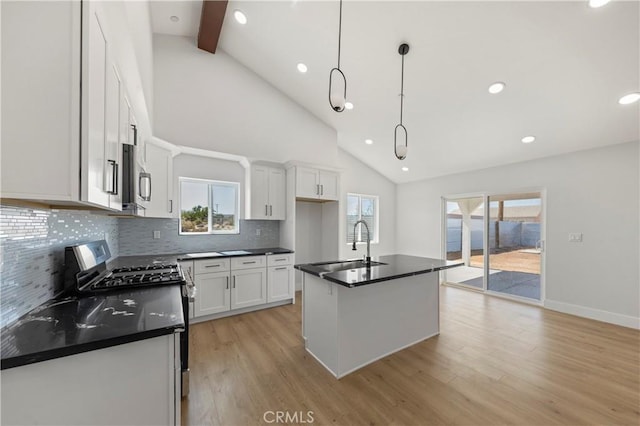 58424 Canterbury St, Yucca Valley, CA 92284 - kitchen with appliances with stainless steel finishes, dark countertops, backsplash, light wood finished floors, and beam ceiling