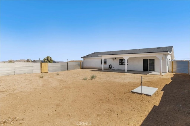58424 Canterbury St, Yucca Valley, CA 92284 - rear view of property featuring a patio, stucco siding, and a fenced backyard
