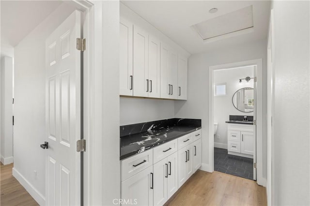 58424 Canterbury St, Yucca Valley, CA 92284 - kitchen with dark countertops, light wood-style flooring, and white cabinetry