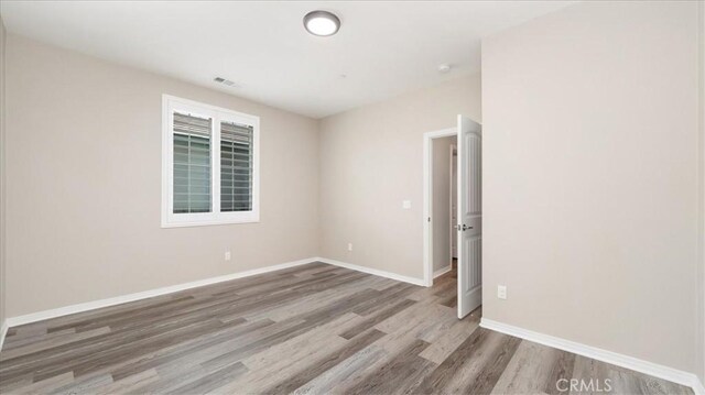 5120 Armendarez Ln, Fontana, CA 92336 - empty room featuring wood finished floors and baseboards