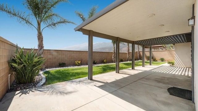 5120 Armendarez Ln, Fontana, CA 92336 - fenced backyard with a patio area and a mountain view