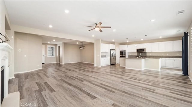 5120 Armendarez Ln, Fontana, CA 92336 - unfurnished living room with a ceiling fan, light wood-style flooring, recessed lighting, and a fireplace
