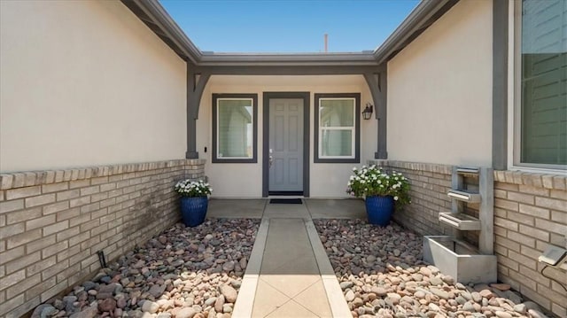 5120 Armendarez Ln, Fontana, CA 92336 - doorway to property featuring stucco siding and brick siding