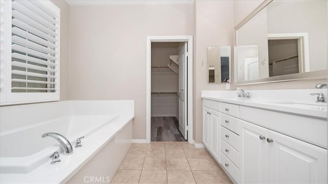 5120 Armendarez Ln, Fontana, CA 92336 - bathroom with double vanity, a garden tub, a spacious closet, and tile patterned flooring