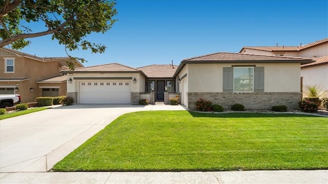 5120 Armendarez Ln, Fontana, CA 92336 - view of front of home with a garage, stucco siding, a front lawn, driveway, and brick siding