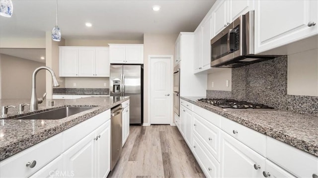 5120 Armendarez Ln, Fontana, CA 92336 - kitchen featuring appliances with stainless steel finishes, light wood-type flooring, white cabinets, hanging light fixtures, and recessed lighting