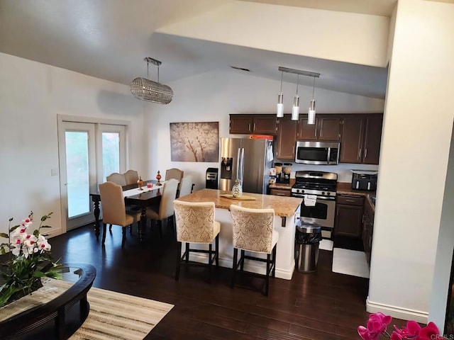 1268 J B Rodriguez St, Calexico, CA 92231 - kitchen with stainless steel appliances, lofted ceiling, dark wood-type flooring, a kitchen breakfast bar, and pendant lighting
