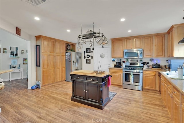 26460 Gem Ct, Helendale, CA 92342 - kitchen with appliances with stainless steel finishes, light wood finished floors, recessed lighting, a kitchen island, and wood counters