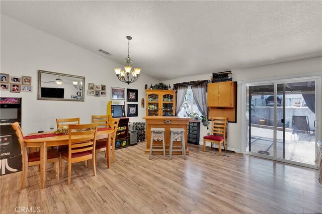 26460 Gem Ct, Helendale, CA 92342 - dining space featuring a chandelier, light wood finished floors, and a textured ceiling