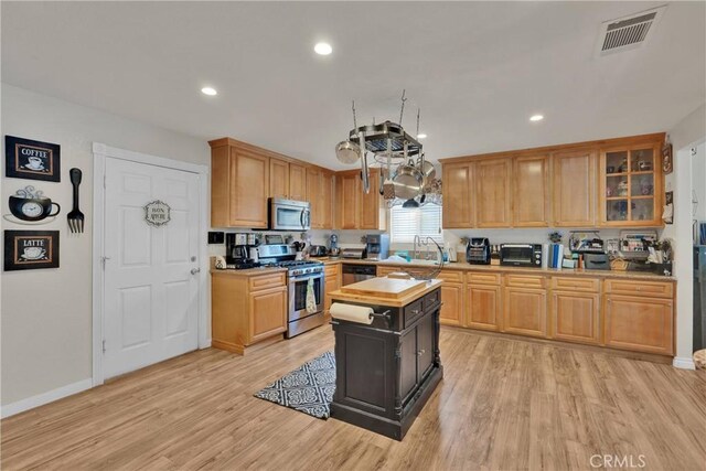 26460 Gem Ct, Helendale, CA 92342 - kitchen featuring stainless steel appliances, light wood finished floors, recessed lighting, glass insert cabinets, and a center island