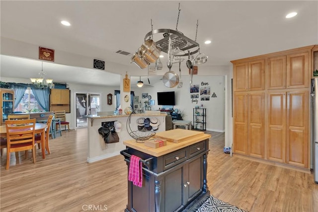 26460 Gem Ct, Helendale, CA 92342 - kitchen with open floor plan, a kitchen island, a chandelier, light wood-type flooring, and recessed lighting