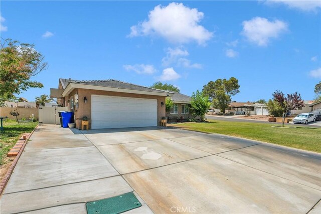 26460 Gem Ct, Helendale, CA 92342 - single story home featuring driveway, stucco siding, an attached garage, and a gate