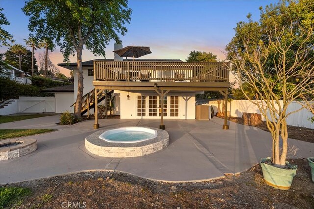 24135 Las Naranjas Dr, Laguna Niguel, CA 92677 - back of property at dusk with french doors, a deck, a fenced backyard, and a patio area