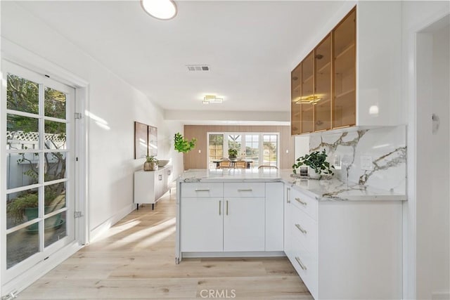 24135 Las Naranjas Dr, Laguna Niguel, CA 92677 - kitchen featuring a peninsula, healthy amount of natural light, and light stone countertops