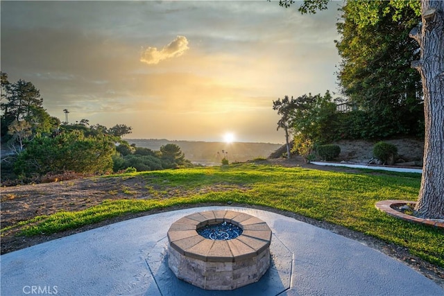 24135 Las Naranjas Dr, Laguna Niguel, CA 92677 - patio terrace at dusk featuring an outdoor fire pit, a patio area, and a yard
