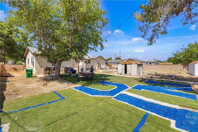 1022 E Lancaster Blvd, Lancaster, CA 93535 - fenced backyard with a storage unit and a patio area