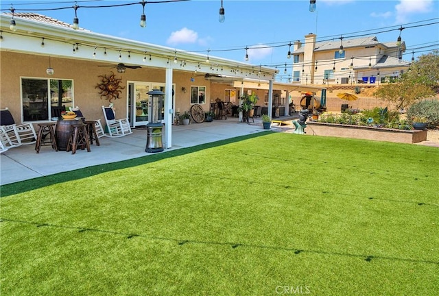 19420 Red Feather Rd, Apple Valley, CA 92307 - rear view of house featuring a patio area, stucco siding, a yard, and ceiling fan