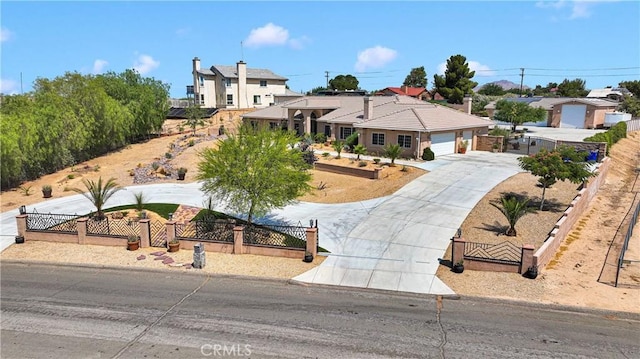 19420 Red Feather Rd, Apple Valley, CA 92307 - view of front of house featuring a fenced front yard, concrete driveway, a garage, and a gate
