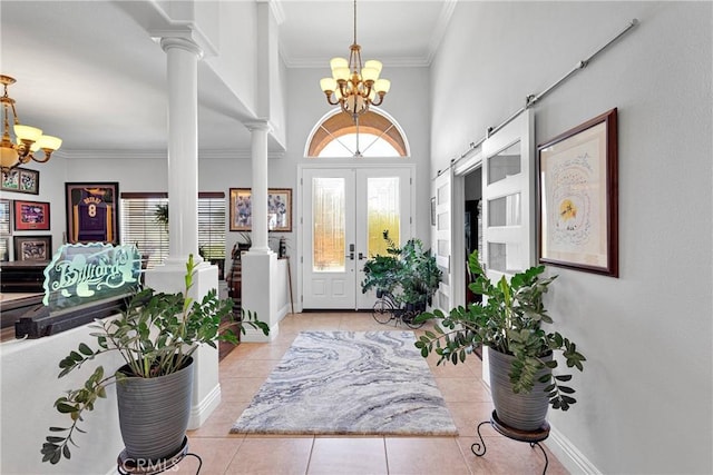 19420 Red Feather Rd, Apple Valley, CA 92307 - foyer featuring a chandelier, ornate columns, ornamental molding, and light tile patterned flooring