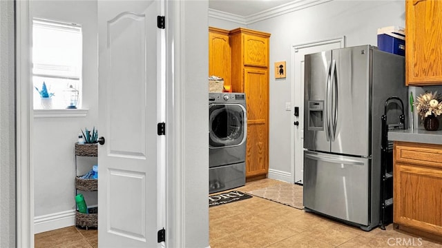 19420 Red Feather Rd, Apple Valley, CA 92307 - laundry room with washer / dryer, ornamental molding, light tile patterned floors, and cabinet space
