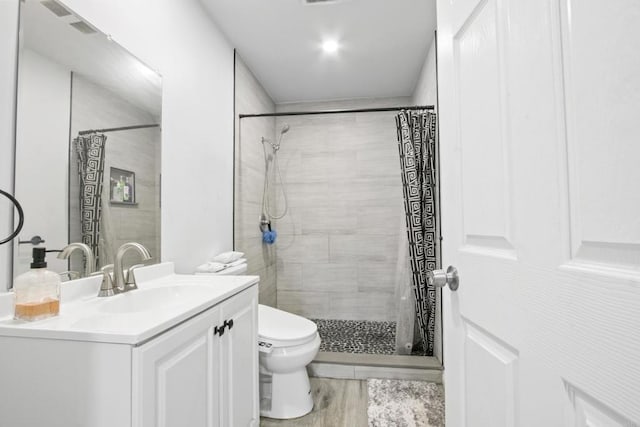 4903 Deeboyar Ave, Lakewood, CA 90712 - full bath featuring vanity, tiled shower, and wood finished floors
