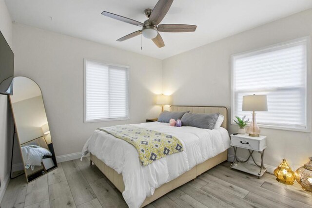 4903 Deeboyar Ave, Lakewood, CA 90712 - bedroom with light wood-style flooring, multiple windows, and ceiling fan