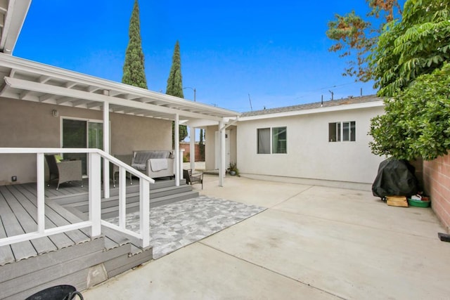4903 Deeboyar Ave, Lakewood, CA 90712 - rear view of house featuring stucco siding, a deck, outdoor lounge area, and a patio area