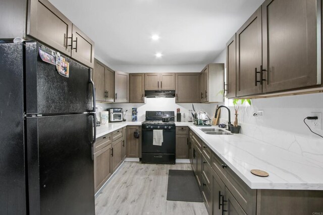 4903 Deeboyar Ave, Lakewood, CA 90712 - kitchen featuring black appliances, under cabinet range hood, light wood-style flooring, light stone counters, and recessed lighting