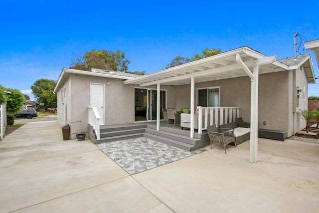 4903 Deeboyar Ave, Lakewood, CA 90712 - back of property featuring stucco siding, an outdoor living space, and a patio area
