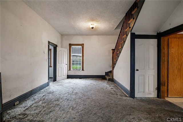 707 Marin St, Corning, CA 96021 - spare room featuring carpet, stairs, and a textured ceiling