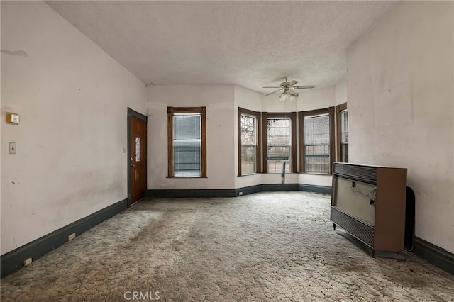707 Marin St, Corning, CA 96021 - unfurnished living room featuring carpet flooring, ceiling fan, heating unit, and a textured ceiling