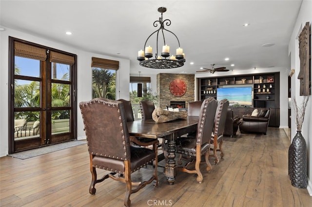5390 Carlsbad Blvd, Carlsbad, CA 92008 - dining space featuring a chandelier, wood-type flooring, a fireplace, recessed lighting, and a ceiling fan