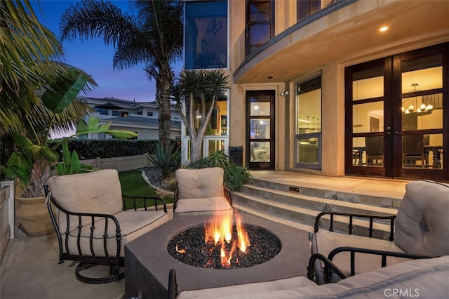 5390 Carlsbad Blvd, Carlsbad, CA 92008 - patio terrace at dusk with a fire pit, french doors, and a patio area