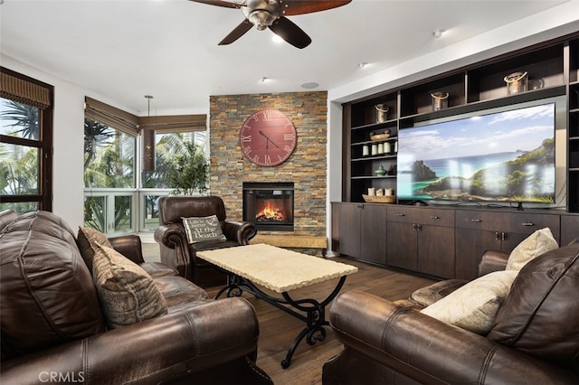 5390 Carlsbad Blvd, Carlsbad, CA 92008 - living area with dark wood-style floors, a ceiling fan, and a stone fireplace
