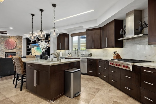 5390 Carlsbad Blvd, Carlsbad, CA 92008 - kitchen featuring stainless steel appliances, wall chimney range hood, an island with sink, backsplash, and recessed lighting