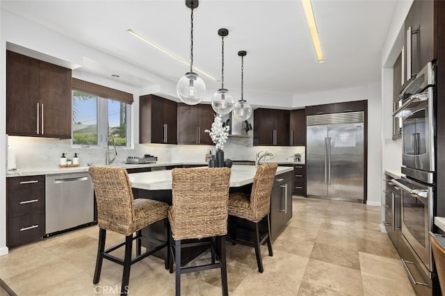 5390 Carlsbad Blvd, Carlsbad, CA 92008 - kitchen featuring stainless steel appliances, a kitchen island, light countertops, and decorative backsplash